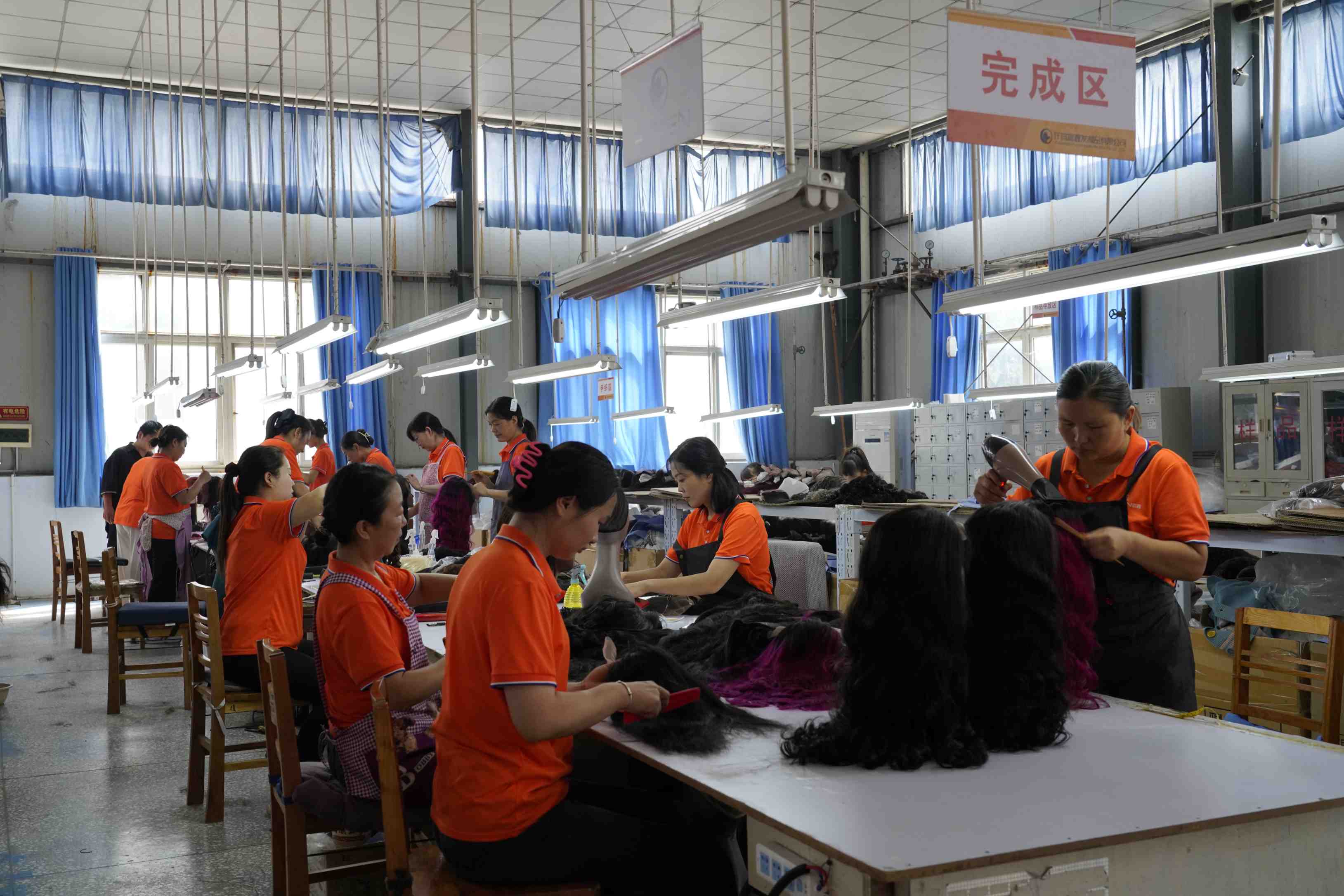 FoxenHair Workers engaged in sewing tasks in a factory